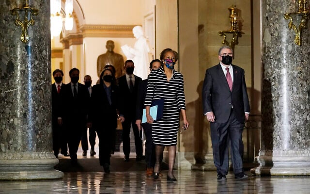 Clerk of the House Cheryl Johnson along with acting House Sergeant-at-Arms Tim Blodgett, lead the Democratic House impeachment managers as they walk through Statuary Hall in the Capitol, to deliver to the Senate the article of impeachment alleging incitement of insurrection against former President Donald Trump, Monday, Jan. 25, 2021 in Washington. (AP Photo/Susan Walsh) Clerk of the House Cheryl Johnson along with acting House Sergeant-at-Arms Tim Blodgett, lead the Democratic House impeachment managers as they walk through Statuary Hall in the Capitol, to deliver to the Senate the article of impeachment alleging incitement of insurrection against former President Donald Trump, Monday, Jan. 25, 2021 in Washington. (AP Photo/Susan Walsh)