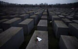 File: Roses with a note saying "#weremember" are placed on the Holocaust Memorial on International Holocaust Remembrance Day, in Berlin, Germany, January 27, 2021. (AP Photo/ Markus Schreiber)
