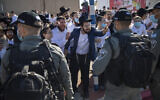 Illustrative: Ultra-Orthodox Jews argue with Israeli border police officers during a protest over the coronavirus lockdown restrictions, in Ashdod, January 24, 2021. (AP/Oded Balilty)