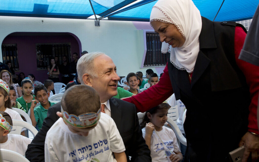 Illustrative: Prime Minister Benjamin Netanyahu poses for a photograph with pupils on the first day of school in the Israeli Arab town of Tamra, Thursday, September 1, 2016. (AP/Sebastian Scheiner) Illustrative: Prime Minister Benjamin Netanyahu poses for a photograph with pupils on the first day of school in the Israeli Arab town of Tamra, Thursday, September 1, 2016. (AP/Sebastian Scheiner)