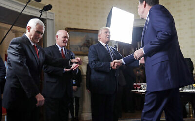 In this this Jan. 22, 2017, file photo, Vice President Mike Pence, left, and Secret Service Director Joseph Clancy stand as President Donald Trump shakes hands with then-FBI Director James Comey during a reception for inaugural law enforcement officers and first responders in the Blue Room of the White House in Washington. (AP Photo/Alex Brandon)