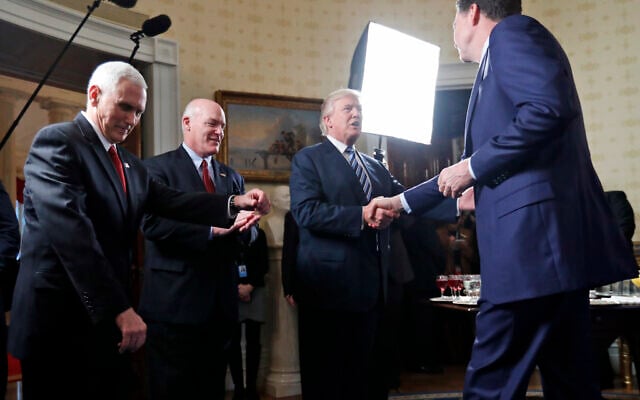 In this this Jan. 22, 2017, file photo, Vice President Mike Pence, left, and Secret Service Director Joseph Clancy stand as President Donald Trump shakes hands with then-FBI Director James Comey during a reception for inaugural law enforcement officers and first responders in the Blue Room of the White House in Washington. (AP Photo/Alex Brandon) In this this Jan. 22, 2017, file photo, Vice President Mike Pence, left, and Secret Service Director Joseph Clancy stand as President Donald Trump shakes hands with then-FBI Director James Comey during a reception for inaugural law enforcement officers and first responders in the Blue Room of the White House in Washington. (AP Photo/Alex Brandon)