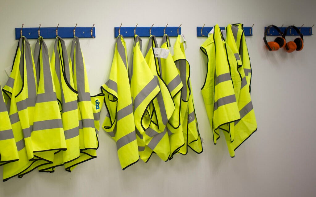 Illustrative: Safety jackets hang at a factory in southern Israel on March 13, 2018. (AP/Ariel Schalit) Illustrative: Safety jackets hang at a factory in southern Israel on March 13, 2018. (AP/Ariel Schalit)