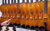 Illustrative -- Violins hang next to each other at the Music Fair in Frankfurt, Germany, April 11, 2018. (AP Photo/Michael Probst)