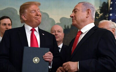 Then-US president Donald Trump (left) smiles at Prime Minister Benjamin Netanyahu after signing a proclamation recognizing the Golan Heights as part of Israel, in the Diplomatic Reception Room at the White House in Washington, on March 25, 2019. (AP Photo/ Susan Walsh)