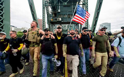 Members of the Proud Boys and other right-wing demonstrators march across the Hawthorne Bridge during an 'End Domestic Terrorism' rally in Portland, Oregon, on August 17, 2019. (AP Photo/Noah Berger)