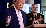 US President Donald Trump speaks in the James Brady Press Briefing Room of the White House, April 1, 2020, in Washington, as Chairman of the Joint Chiefs Gen. Mark Milley listens. (AP Photo/Alex Brandon)