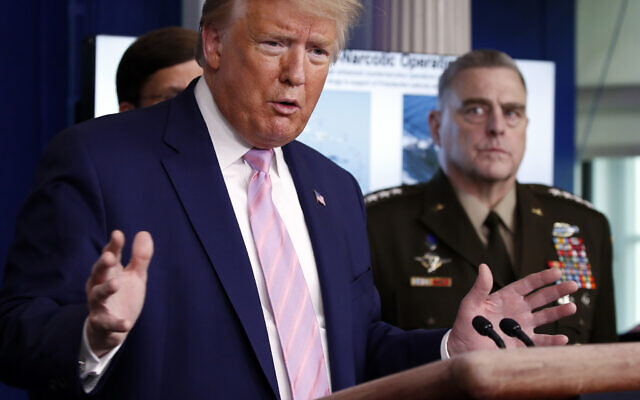 US President Donald Trump speaks in the James Brady Press Briefing Room of the White House, April 1, 2020, in Washington, as Chairman of the Joint Chiefs Gen. Mark Milley listens. (AP Photo/Alex Brandon) US President Donald Trump speaks in the James Brady Press Briefing Room of the White House, April 1, 2020, in Washington, as Chairman of the Joint Chiefs Gen. Mark Milley listens. (AP Photo/Alex Brandon)