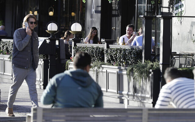 Illustrative -- People sit in an outdoor restaurant area in Christchurch, New Zealand, June 8, 2020 (AP Photo/Mark Baker) Illustrative -- People sit in an outdoor restaurant area in Christchurch, New Zealand, June 8, 2020 (AP Photo/Mark Baker)