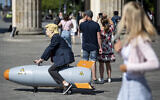Illustrative: An activist dressed up as US President Trump rides a atomic bomb model during a protest for a world without nuclear weapons near the Brandenburg Gate in Berlin, Germany, July 30, 2020.  (Fabian Sommer/dpa via AP)