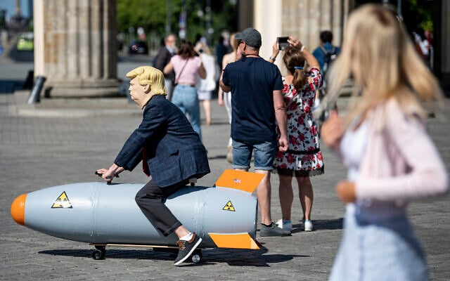 Illustrative: An activist dressed up as US President Trump rides a atomic bomb model during a protest for a world without nuclear weapons near the Brandenburg Gate in Berlin, Germany, July 30, 2020. (Fabian Sommer/dpa via AP) Illustrative: An activist dressed up as US President Trump rides a atomic bomb model during a protest for a world without nuclear weapons near the Brandenburg Gate in Berlin, Germany, July 30, 2020. (Fabian Sommer/dpa via AP)