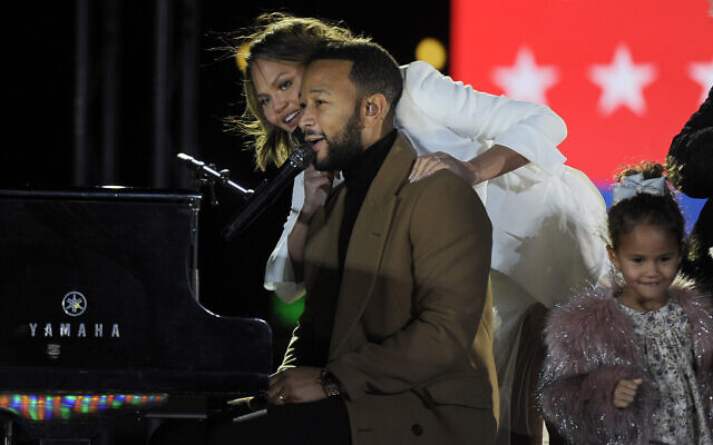 Performer John Legend, his wife Chrissy Teigen and their daughter Luna greet a crowd gathered during a drive-in "get out the vote" rally featuring Democratic vice presidential candidate Kamala Harris, Nov. 2, 2020, in Philadelphia. (AP Photo/Michael Perez) Performer John Legend, his wife Chrissy Teigen and their daughter Luna greet a crowd gathered during a drive-in "get out the vote" rally featuring Democratic vice presidential candidate Kamala Harris, Nov. 2, 2020, in Philadelphia. (AP Photo/Michael Perez)
