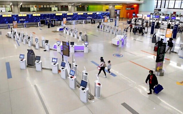 Travelers walk through the nearly empty JetBlue terminal at Logan Airport, Friday Nov. 20, 2020, in Boston. (AP Photo/Michael Dwyer) Travelers walk through the nearly empty JetBlue terminal at Logan Airport, Friday Nov. 20, 2020, in Boston. (AP Photo/Michael Dwyer)
