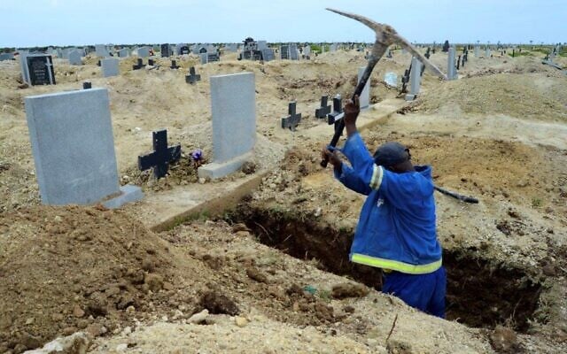 A grave digger prepares graves at the Motherwell Cemetery in Port Elizabeth, South Africa, Friday, Dec. 4, 2020 (AP Photo/Theo Jeftha)