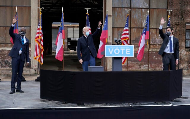 President-elect Joe Biden, center, acknowledge supporters at the end of a drive-in rally for Georgia Democratic candidates for US Senate Raphael Warnock, left, and Jon Ossoff, Dec. 15, 2020, in Atlanta. (AP Photo/Patrick Semansky) President-elect Joe Biden, center, acknowledge supporters at the end of a drive-in rally for Georgia Democratic candidates for US Senate Raphael Warnock, left, and Jon Ossoff, Dec. 15, 2020, in Atlanta. (AP Photo/Patrick Semansky)
