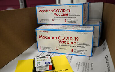 Boxes containing the Moderna COVID-19 vaccine are prepared to be shipped at the McKesson distribution center in Olive Branch, Mississippi, Dec. 20, 2020. (AP Photo/Paul Sancya, Pool)