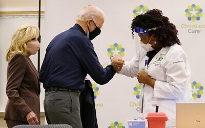 Illustrative: President-elect Joe Biden fist bumps with nurse practitioner Tabe Mase after receiving his first dose of the coronavirus vaccine at ChristianaCare Christiana Hospital in Newark, Del., Monday, Dec. 21, 2020, as Jill Biden looks on. (AP Photo/Carolyn Kaster)