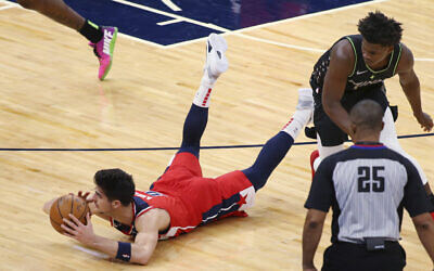 Washington Wizards forward Deni Avdija (9) dives for the ball next to Minnesota Timberwolves guard Anthony Edwards during the first quarter of an NBA basketball game Jan. 1, 2021, in Minneapolis. (AP Photo/Andy Clayton-King)