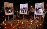 Popular Mobilization Forces and their supporters light candles at Baghdad's international airport on the first anniversary of the killing of Abu Mahdi al-Muhandis, deputy commander of the PMF and Gen. Qassem Soleimani, head of Iran's Quds forces, on January 2, 2021. (Khalid Mohammed/AP)