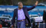 Democratic US Senate candidate Rev. Raphael Warnock waves to supporters during a drive-in rally, Jan. 3, 2021, in Savannah, Georgia (AP Photo/Stephen B. Morton)