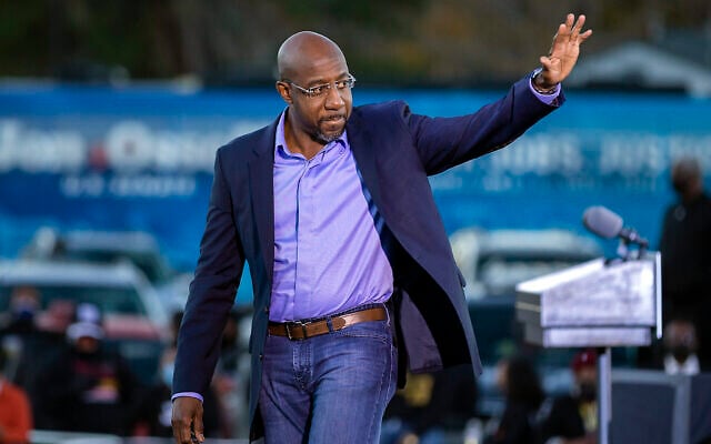 Democratic US Senate candidate Rev. Raphael Warnock waves to supporters during a drive-in rally, Jan. 3, 2021, in Savannah, Georgia (AP Photo/Stephen B. Morton) Democratic US Senate candidate Rev. Raphael Warnock waves to supporters during a drive-in rally, Jan. 3, 2021, in Savannah, Georgia (AP Photo/Stephen B. Morton)