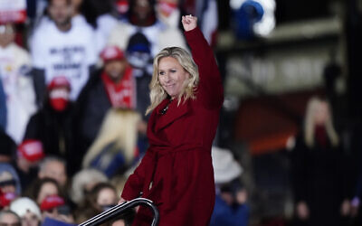 Rep. Marjorie Taylor Greene, R-Ga., gestures as US President Donald Trump speaks at a campaign rally in support of Senate candidates Sen. Kelly Loeffler, R-Ga., and David Perdue in Dalton, Ga., Monday, Jan. 4, 2021. (AP Photo/Brynn Anderson)