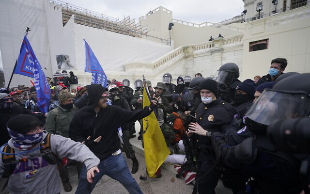 Trump supporters try to break through a police barrier, Wednesday, Jan. 6, 2021, at the Capitol in Washington (AP Photo/Julio Cortez)