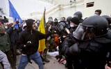 Trump supporters try to break through a police barrier, January 6, 2021, at the US Capitol in Washington. (AP Photo/Julio Cortez)