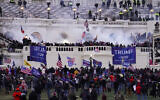 Violent protesters, loyal to President Donald Trump, storm the Capitol, Wednesday, Jan. 6, 2021, in Washington. It's been a stunning day as a number of lawmakers and then the mob of protesters tried to overturn America's presidential election, undercut the nation's democracy and keep Democrat Joe Biden from replacing Trump in the White House. (AP Photo/John Minchillo)