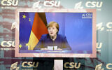 German Chancellor Angela Merkel  seen on a screen as she makes a statement on the events in Washington with the storming of the Capitol building by supporters of US President Donald Trump supporters at the beginning of the digital press conference at the winter retreat of the CSU parliamentary group in the Bundestag, Berlin, Germany, January 7, 2021. (Kay Nietfeld/Pool via AP)