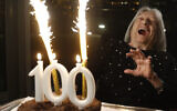 Agnes Keleti, former Olympic gold medal winning gymnast, reacts to fireworks going off on her birthday cake in Budapest, Hungary, Jan. 4, 2021 (AP Photo/Laszlo Balogh)