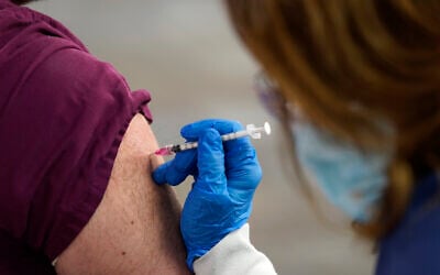 Illustrative: A healthcare worker receives a second Pfizer-BioNTech COVID-19 vaccine shot at Beaumont Health in Southfield, Michigan, January 5, 2021. (AP Photo/Paul Sancya, File)