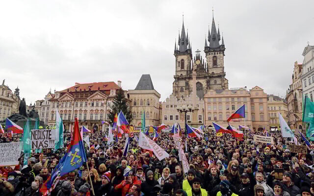 Demonstrators gather during a protest against the government restriction measures to curb the spread of COVID-19, in Prague, Czech Republic, January 10, 2021. (AP Photo/Petr David Josek)