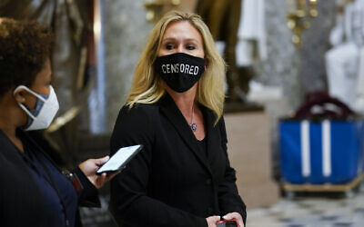 Rep. Marjorie Taylor Greene, R-Ga., walks on Capitol Hill in Washington, Wednesday, Jan. 13, 2021. (AP Photo/Susan Walsh)