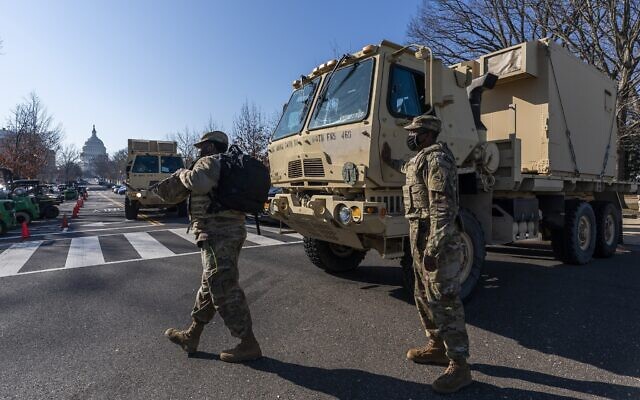 Members of the National Guard secure the perimeter around the Capitol, Wednesday, Jan. 13, 2021, in Washington as the House of Representatives continues with its fast-moving House vote to impeach President Donald Trump, a week after a mob of Trump supporters stormed the US Capitol. (AP Photo/Manuel Balce Ceneta)