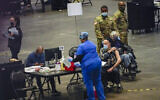 Seniors are vaccinated against COVID-19 at a New York State vaccination site in the Jacob K. Javits Convention Center, January 13, 2021, in New York. (AP/Mary Altaffer)