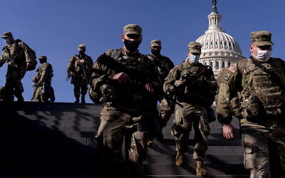 Members of the National Guard walk past the Dome of the Capitol Building on Capitol Hill in Washington Jan. 14, 2021. (AP/Andrew Harnik)