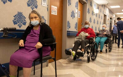 Nursing home residents in line to receive COVID-19 vaccines at Harlem Center for Nursing and Rehabilitation, a nursing home facility in New York, January 15, 2021. (AP Photo/Yuki Iwamura)