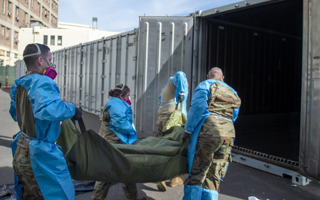 Illustrative: National Guard members assist with processing COVID-19 deaths and placing them into temporary storage at LA County Medical Examiner-Coroner Office in Los Angeles, January 12, 2021. (LA County Dept. of Medical Examiner-Coroner via AP, File)