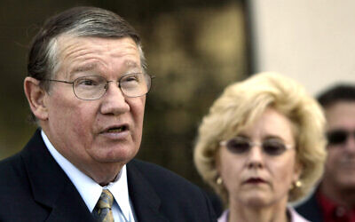 Then-Rep. Randy "Duke" Cunningham, flanked by his wife Nancy, announces he will not seek reelection during a news conference in San Marcos, California, July 14, 2005. (AP Photo/Lenny Ignelzi, Files)