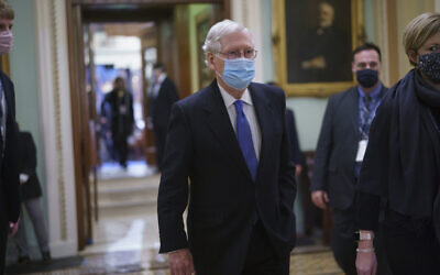 Sen. Mitch McConnell, R-Ky., the top Republican in Senate, leaves the chamber after Vice President Kamala Harris swore in three new Democratic senators, at the Capitol in Washington, Wednesday, Jan. 20, 2021. The victory by the two candidates in the pivotal Georgia runoff election this month was decisive in handing Democrats the majority in the Senate and forcing McConnell to become the minority leader. (AP Photo/J. Scott Applewhite)