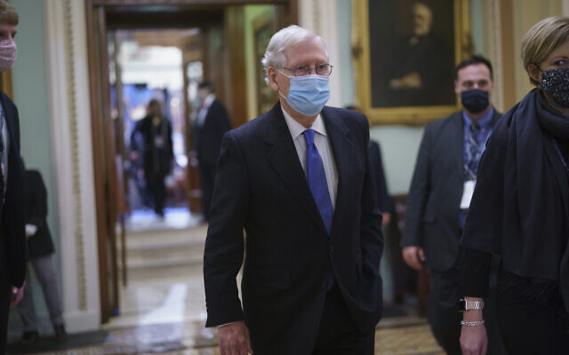 Sen. Mitch McConnell, R-Ky., the top Republican in Senate, leaves the chamber after Vice President Kamala Harris swore in three new Democratic senators, at the Capitol in Washington, Wednesday, Jan. 20, 2021. The victory by the two candidates in the pivotal Georgia runoff election this month was decisive in handing Democrats the majority in the Senate and forcing McConnell to become the minority leader. (AP Photo/J. Scott Applewhite) Sen. Mitch McConnell, R-Ky., the top Republican in Senate, leaves the chamber after Vice President Kamala Harris swore in three new Democratic senators, at the Capitol in Washington, Wednesday, Jan. 20, 2021. The victory by the two candidates in the pivotal Georgia runoff election this month was decisive in handing Democrats the majority in the Senate and forcing McConnell to become the minority leader. (AP Photo/J. Scott Applewhite)