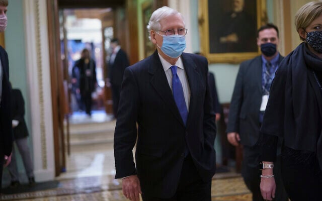Senator Mitch McConnell, the top Republican in the US Senate, leaves the chamber after Vice President Kamala Harris swore in three new Democratic senators, at the Capitol in Washington, January 20, 2021. (AP Photo/J. Scott Applewhite) Senator Mitch McConnell, the top Republican in the US Senate, leaves the chamber after Vice President Kamala Harris swore in three new Democratic senators, at the Capitol in Washington, January 20, 2021. (AP Photo/J. Scott Applewhite)