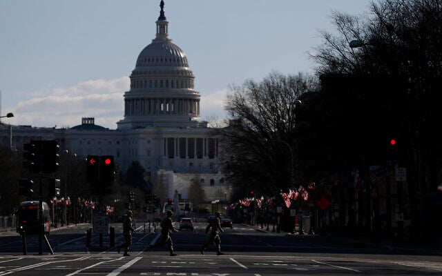National Guard members jog across a road leading to the Capitol, after most downtown streets and public spaces had reopened to the public following the inauguration of President Joe Biden, on Saturday, Jan. 23, 2021 in Washington.(AP Photo/Rebecca Blackwell) National Guard members jog across a road leading to the Capitol, after most downtown streets and public spaces had reopened to the public following the inauguration of President Joe Biden, on Saturday, Jan. 23, 2021 in Washington.(AP Photo/Rebecca Blackwell)