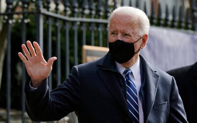 US President Joe Biden waves as he departs after attending Mass at Holy Trinity Catholic Church, Sunday, Jan. 24, 2021, in the Georgetown neighborhood of Washington. (AP Photo/Patrick Semansky)