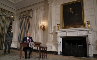 US Vice President Kamala Harris looks on as President Joe Biden signs a series of executive orders in the State Dining Room of the White House, January 26, 2021, in Washington. (AP Photo/Evan Vucci)