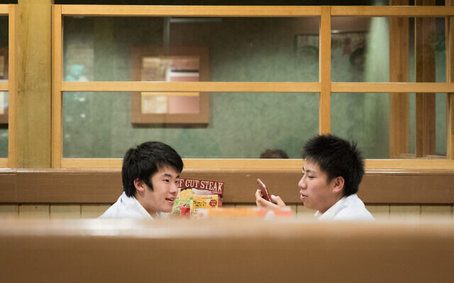 Young men at a restaurant in Tokyo, Japan. November 17, 2019. (Nati Shohat/FLASH90)