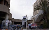 Illustrative -- A Magen David Adom ambulance enters Tel Aviv’s Dan Panorama hotel which was turned into quarantine facility in Tel Aviv, on March 26, 2020 (Gili Yaari /Flash90)
