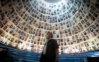 A Yad Vashem security guard in the empty Hall of Names in the Yad Vashem Holocaust Memorial Museum in Jerusalem on April 19, 2020. (Yonatan Sindel/Flash90)