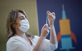 A medical worker prepares a COVID-19 vaccine in Ichilov Hospital in Tel Aviv on December 20, 2020. (Miriam Alster/Flash90)